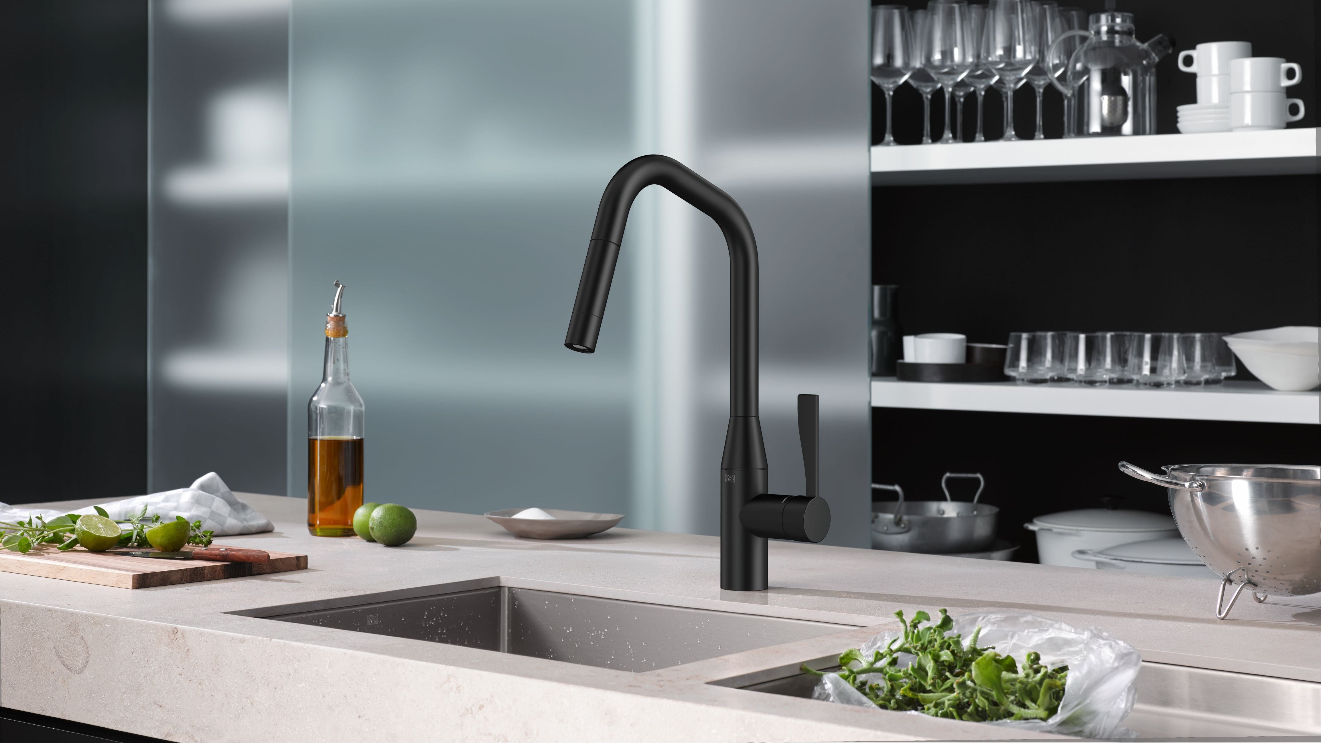 Modern kitchen with a black faucet over a sink, shelves with kitchenware in the background.