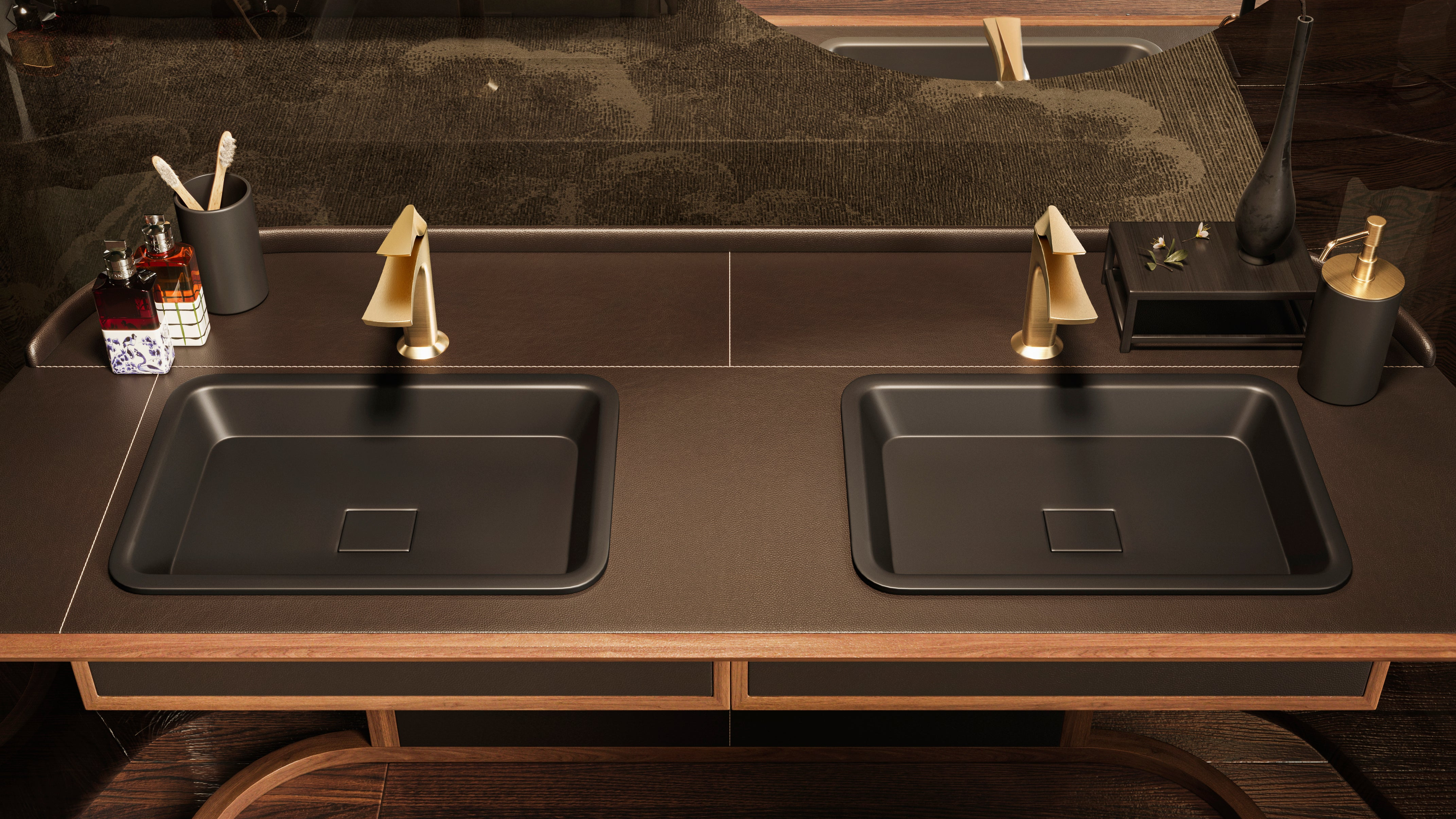 Bathroom vanity with black sinks and gold fixtures