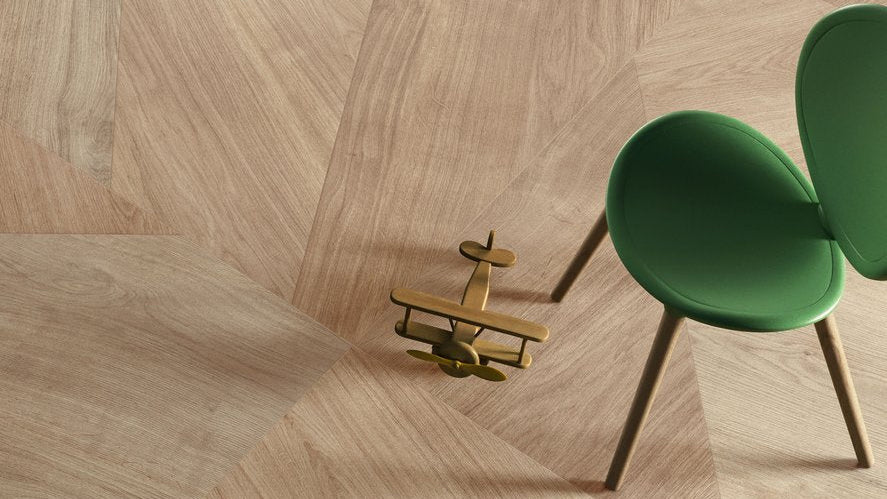 Wooden floor with a green chair and small model airplane